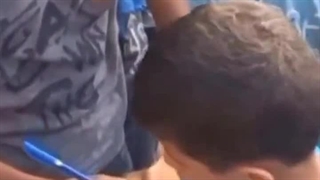 Children in Gaza write their names on their hands because of the high probability of death